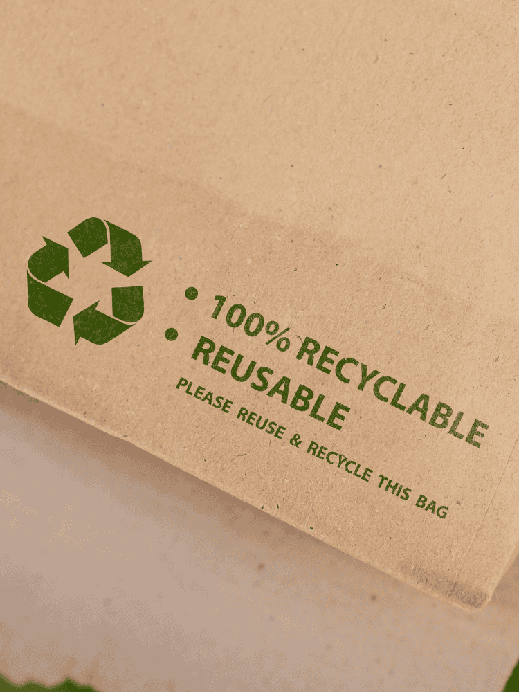 A paper bag with the text 100% recyclable.