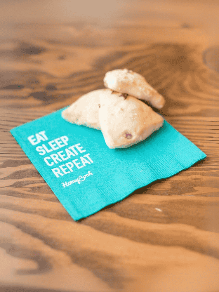 Turquoise napkin with the text EAT SLEEP CREATE REPEAT.