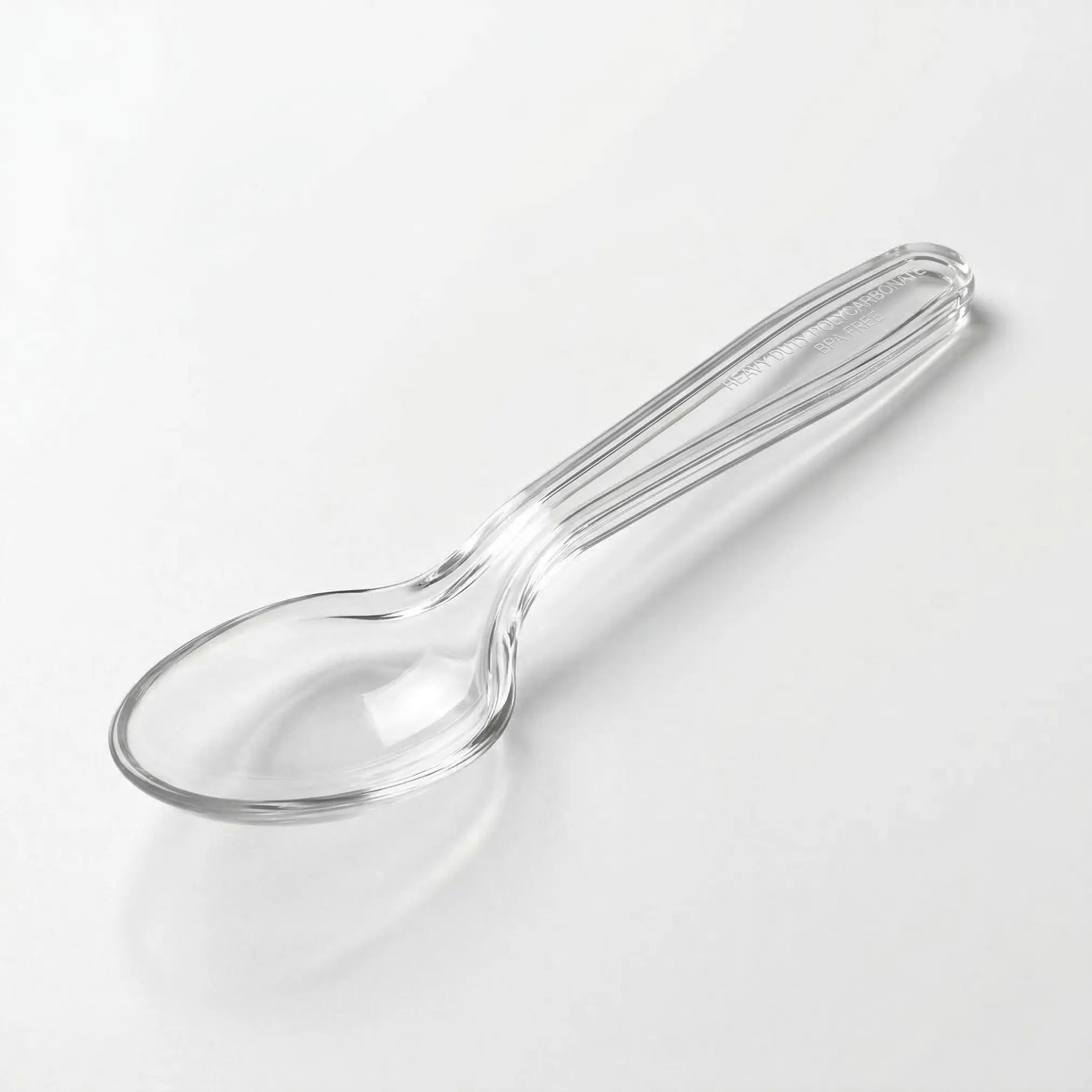 A Clear Plastic Spoons 1000 Pack is displayed on a white surface, highlighting its handle and bowl—ideal disposable cutlery for events and gatherings.