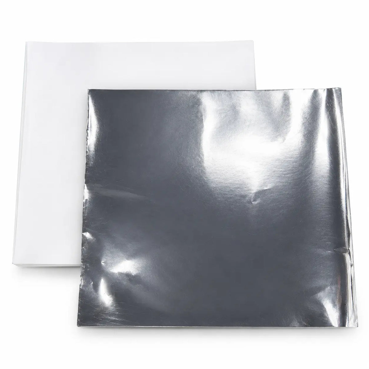 A Foil-Lined Paper Wrap Sheet, measuring 12 x 12 inches, with a shiny silver foil side often used as a grease barrier for sandwich wrapping, is placed on top of another square white sheet, both lying flat on a plain surface.